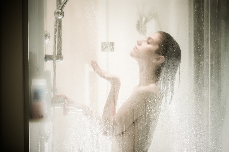 Beautiful brunette woman taking shower after long stressful day.Woman showering and enjoying bath.Using douche shower gel,body lotion,shower relaxing muscles.Depilation and anti cellulite treatment
